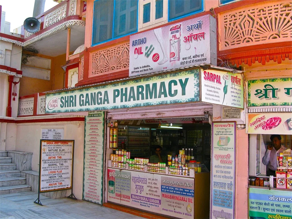 Street-facing Ayurvedic pharmacy in Rishikesh with medicine signboards